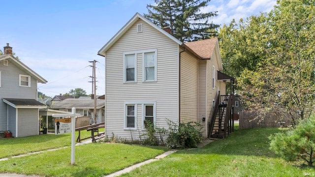 view of side of home featuring a yard