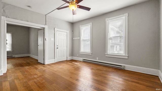 entrance foyer featuring ceiling fan, a baseboard radiator, and hardwood / wood-style floors