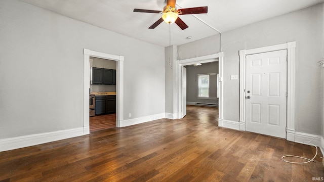 empty room with a baseboard heating unit, dark wood-type flooring, and ceiling fan