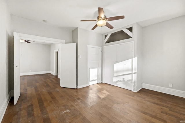 empty room with dark hardwood / wood-style floors and ceiling fan