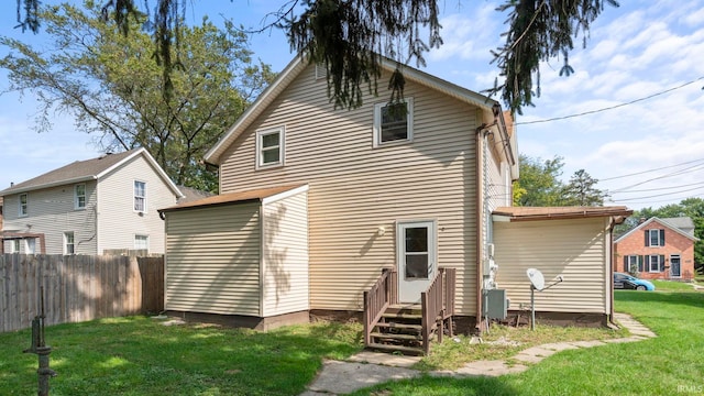 rear view of house with a yard