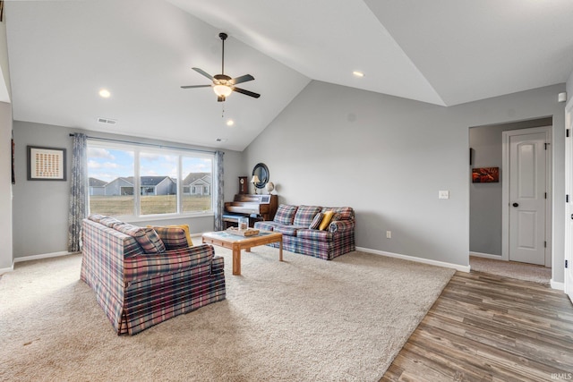 living room with lofted ceiling, hardwood / wood-style floors, and ceiling fan