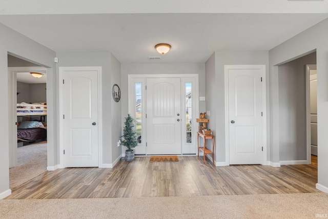 foyer entrance with light wood-type flooring