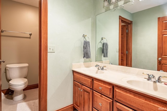 bathroom with vanity, tile patterned flooring, and toilet