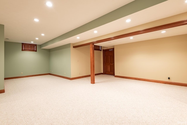 basement featuring light colored carpet