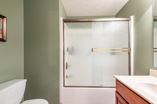 full bathroom with toilet, vanity, bath / shower combo with glass door, and a textured ceiling