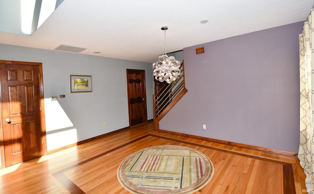 interior space featuring hardwood / wood-style floors and a chandelier