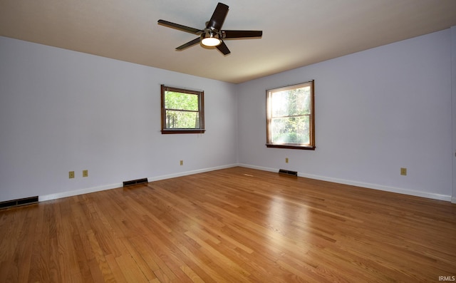 spare room with light hardwood / wood-style flooring, plenty of natural light, and ceiling fan