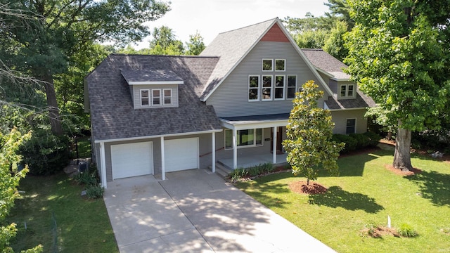 view of front of house with a garage, covered porch, and a front lawn