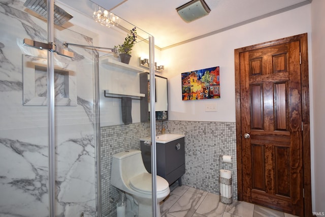 bathroom featuring a shower with shower door, tile walls, vanity, ornamental molding, and toilet