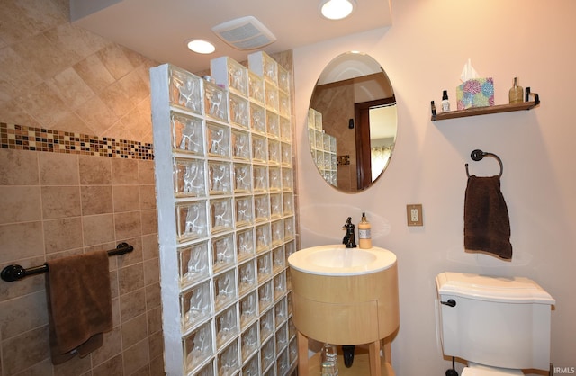 bathroom with sink and a tile shower