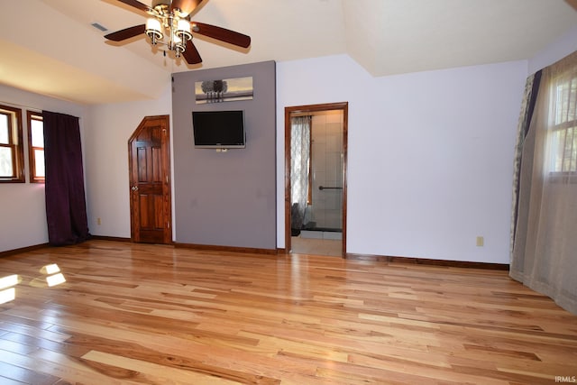 unfurnished room with vaulted ceiling, light hardwood / wood-style floors, and ceiling fan