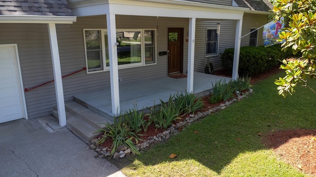 doorway to property featuring a lawn and a porch