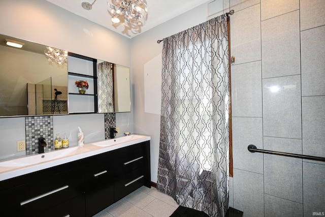 bathroom featuring vanity, tile patterned flooring, decorative backsplash, and an inviting chandelier