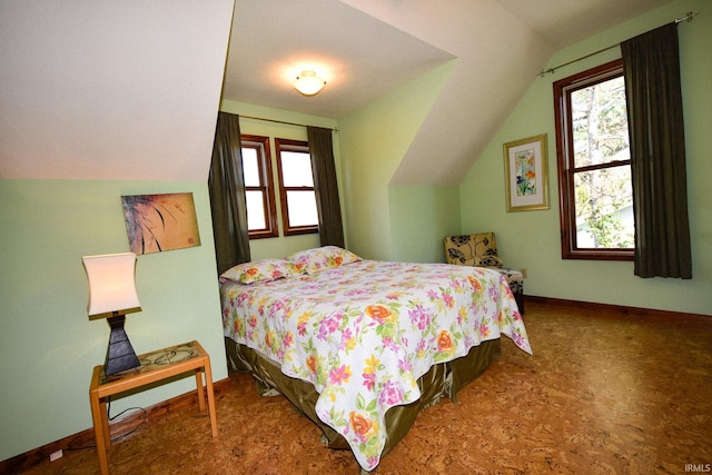 bedroom with multiple windows and lofted ceiling