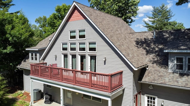 rear view of property with central AC, a patio, and a balcony