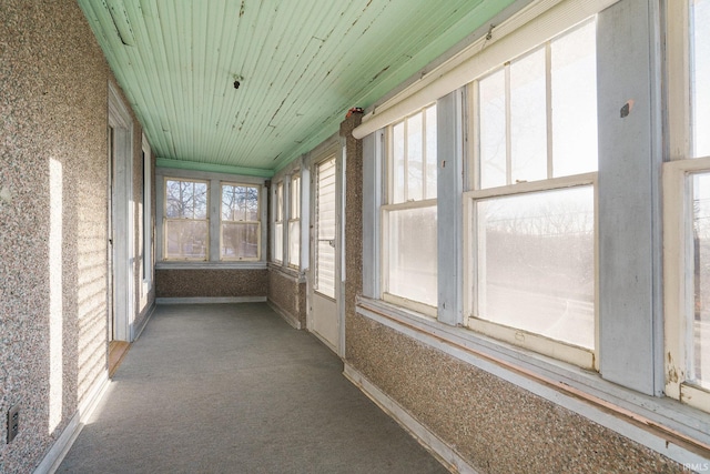 unfurnished sunroom featuring wood ceiling