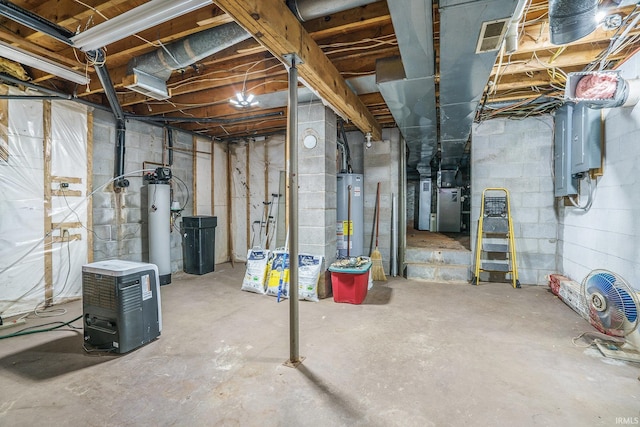 basement featuring heating unit, electric panel, and water heater