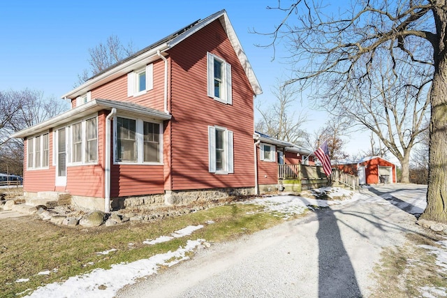 view of side of property featuring a garage and an outdoor structure