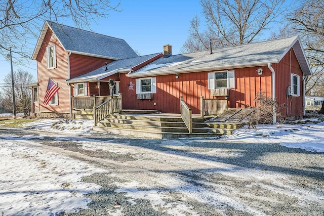 view of snow covered rear of property