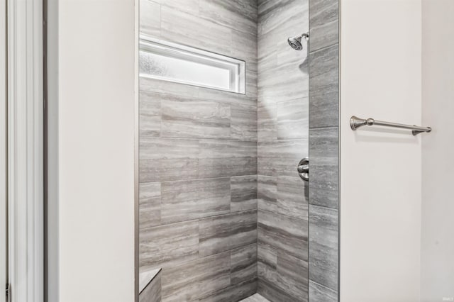 bathroom with a tile shower