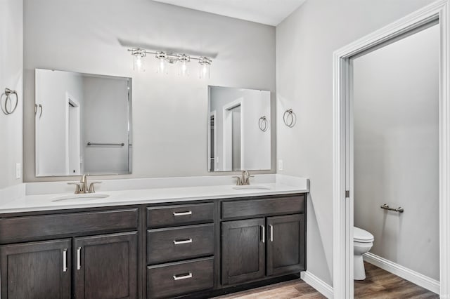 bathroom featuring vanity, hardwood / wood-style floors, and toilet