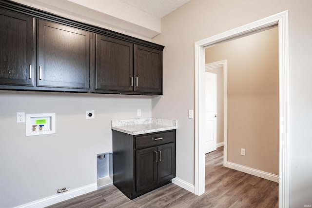 laundry area with cabinets, hookup for an electric dryer, hardwood / wood-style flooring, and washer hookup