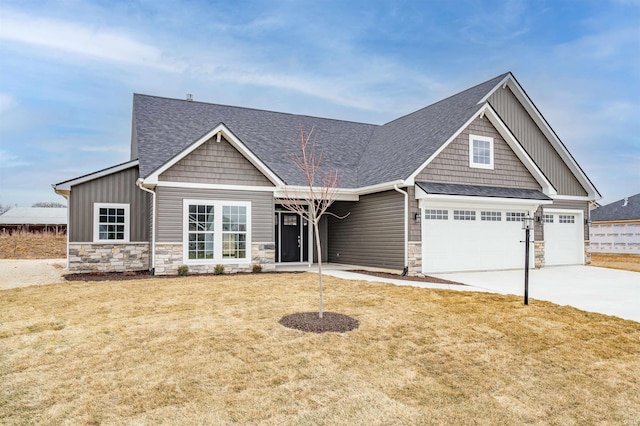 craftsman-style house with a garage and a front lawn