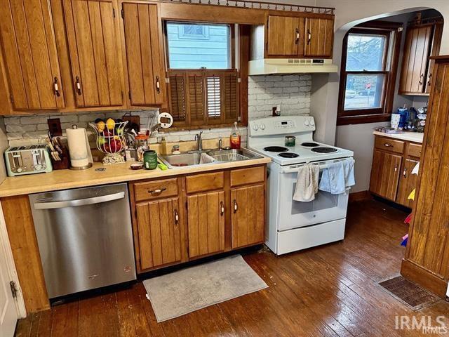 kitchen with dark wood-type flooring, sink, dishwasher, electric stove, and decorative backsplash