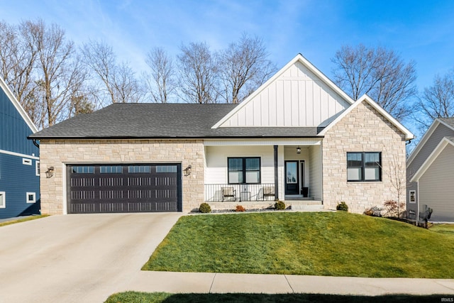 view of front of home featuring a garage, covered porch, and a front lawn