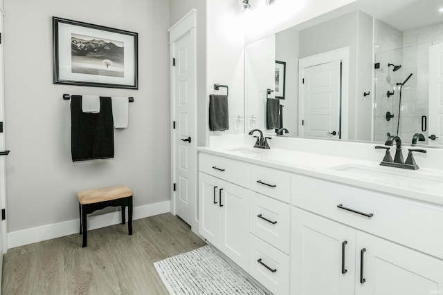 bathroom featuring vanity, wood-type flooring, and walk in shower