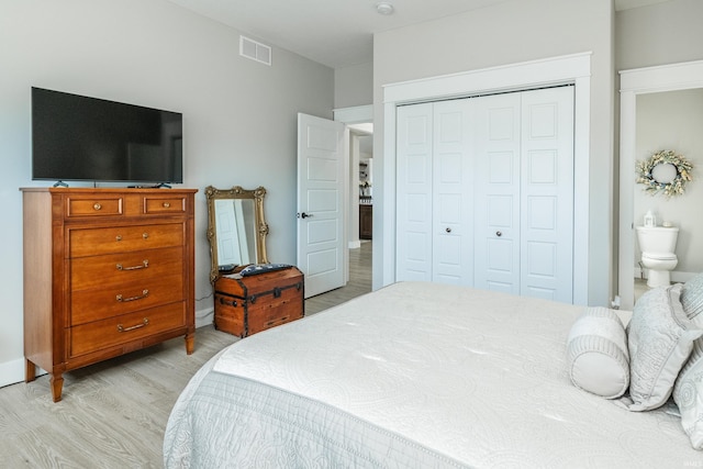 bedroom featuring light hardwood / wood-style flooring and a closet