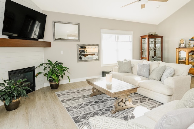 living room featuring lofted ceiling, hardwood / wood-style floors, and ceiling fan