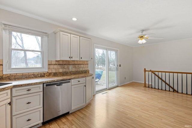 kitchen featuring crown molding, light hardwood / wood-style flooring, dishwasher, white cabinets, and backsplash