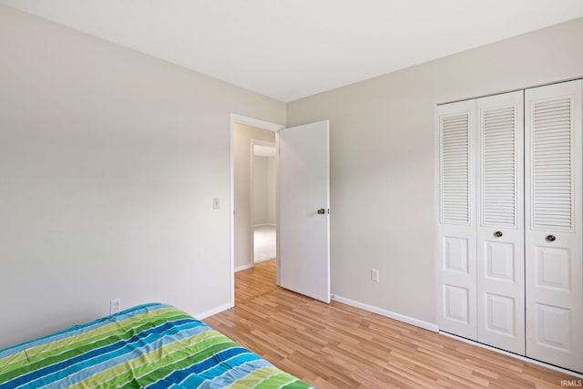 unfurnished bedroom featuring wood-type flooring and a closet