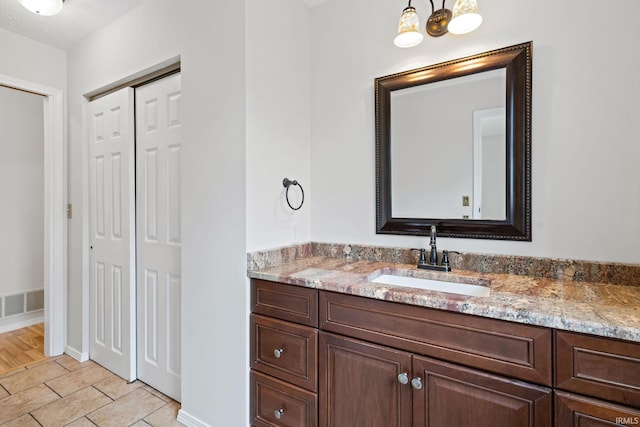 bathroom with vanity and tile patterned flooring