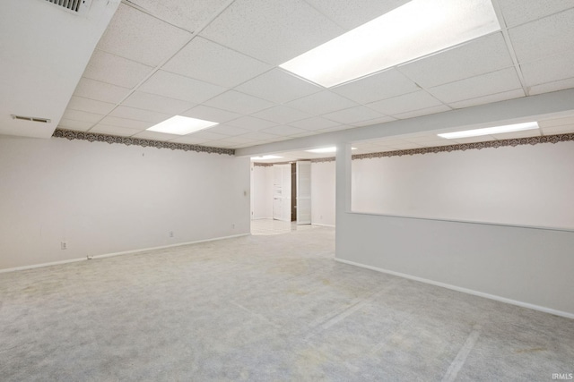 basement with carpet floors and a paneled ceiling