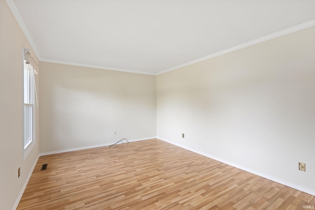 unfurnished room featuring crown molding and light wood-type flooring