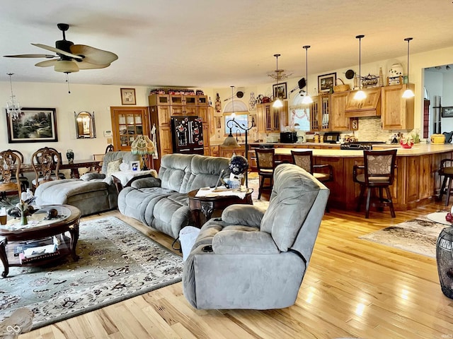 living room featuring light hardwood / wood-style floors and ceiling fan