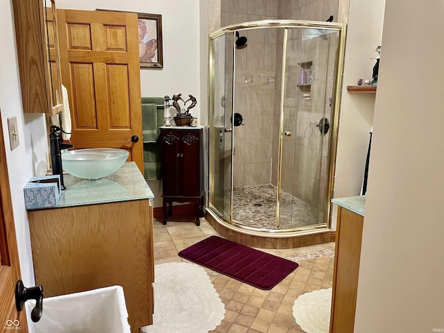 bathroom featuring vanity and an enclosed shower