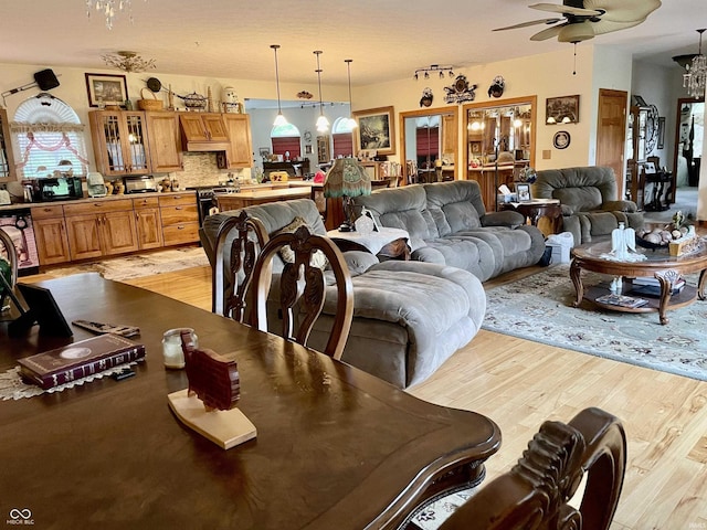 dining space with light hardwood / wood-style floors and ceiling fan