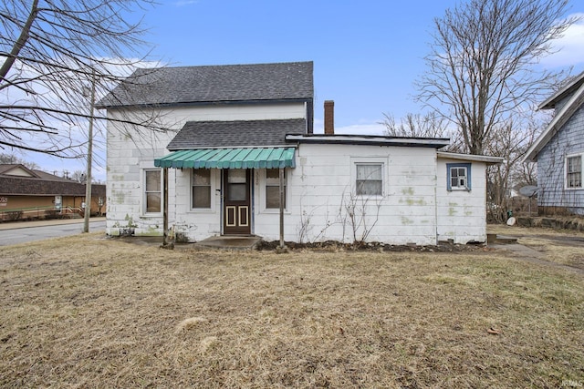 bungalow-style home with a front yard