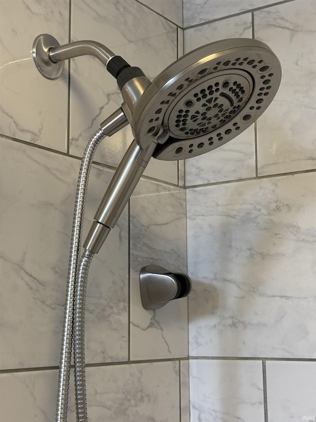 interior details featuring tiled shower