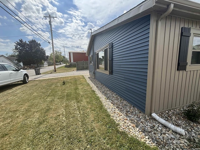 view of property exterior featuring a lawn