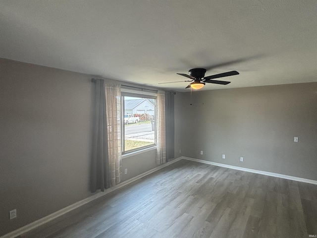 spare room featuring ceiling fan and hardwood / wood-style floors