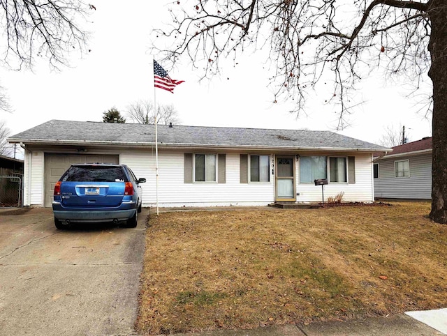 ranch-style house featuring a garage and a front lawn