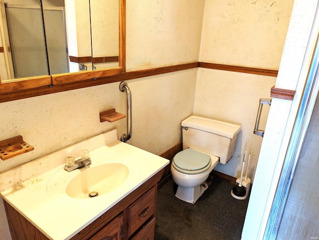 bathroom featuring vanity and toilet