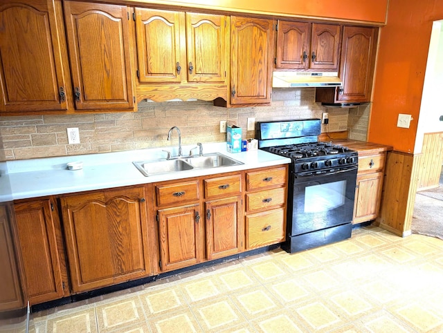 kitchen featuring tasteful backsplash, sink, and black gas range