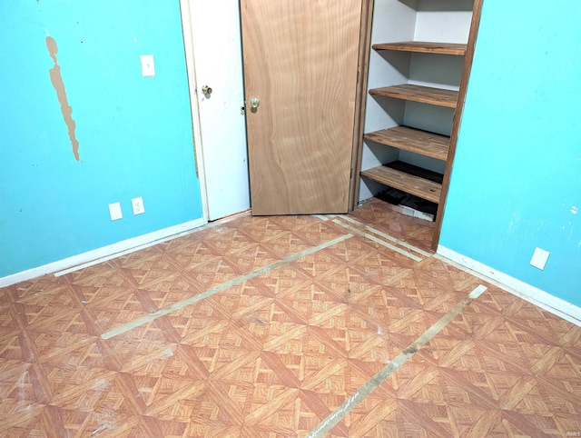 unfurnished bedroom with parquet flooring