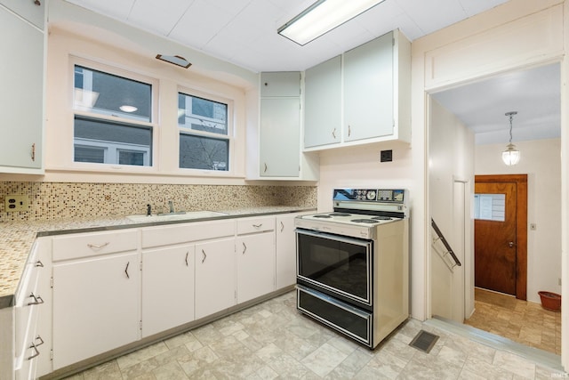 kitchen featuring sink, backsplash, white cabinets, decorative light fixtures, and white electric stove